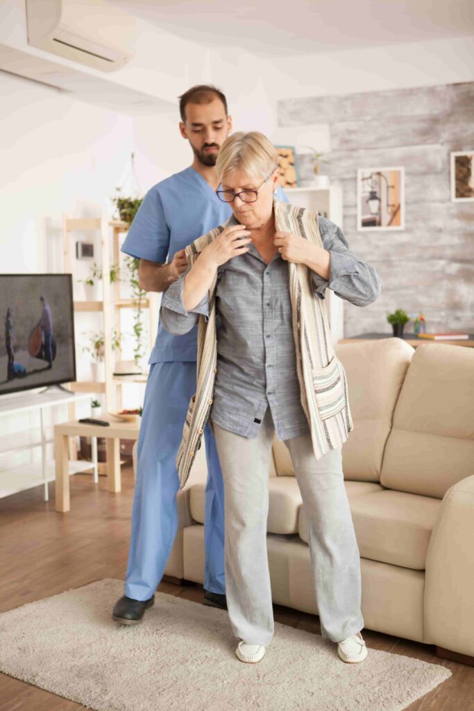 A man and woman standing together in a living room, both dressed professionally as heart caregivers.